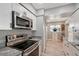 Updated kitchen featuring stainless steel appliances, white cabinets, and granite countertops at 1325 Bottlebrush Dr, Bradenton, FL 34208