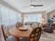 Bright living room featuring a dining table, sectional sofa, and large windows with sheer curtains at 1325 Bottlebrush Dr, Bradenton, FL 34208