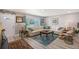 Cozy living room with a comfortable sectional sofa, wood-look floors, and a view of the landscaped yard at 1325 Bottlebrush Dr, Bradenton, FL 34208
