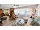 Bright living room featuring a dining table, sectional sofa, and large windows with sheer curtains at 1325 Bottlebrush Dr, Bradenton, FL 34208