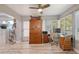 Well-lit home office with a built-in cabinet, desk, and ample natural light at 1325 Bottlebrush Dr, Bradenton, FL 34208