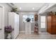 Pantry area with white storage cabinets, window, and a vintage clock at 1325 Bottlebrush Dr, Bradenton, FL 34208