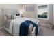 Stylishly decorated bedroom featuring a white wood frame bed, tasteful artwork, and a bright window at 14651 Derna Ter, Bradenton, FL 34211