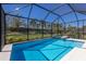 Screened-in pool and spa with a view of the manicured backyard and mature trees at 14651 Derna Ter, Bradenton, FL 34211