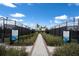 Entrance to well-maintained tennis courts with helpful information and rules for players to enjoy the community's amenities at 14651 Derna Ter, Bradenton, FL 34211
