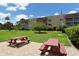 Well-maintained complex featuring picnic tables and a large green lawn, perfect for outdoor enjoyment and community gatherings at 1500 Glen Oaks E Dr # 206, Sarasota, FL 34232