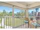 A nice porch with views, seating for two, and tile flooring at 1500 Glen Oaks E Dr # 206, Sarasota, FL 34232