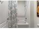 Clean, tiled bathtub and shower combo with a shower curtain at 16966 Rosedown Gln, Parrish, FL 34219