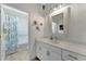 Modern bathroom features vanity with white countertops and tiled shower at 16966 Rosedown Gln, Parrish, FL 34219
