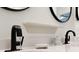 Close up of bathroom sink with Moen faucet, decorative shelf, soap dish, and counter accessories at 16966 Rosedown Gln, Parrish, FL 34219