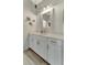 Clean bathroom with updated white cabinets and countertops, stylish mirror, and modern fixtures at 16966 Rosedown Gln, Parrish, FL 34219