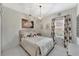 Cozy bedroom with decorative chandelier and a window to bring in natural light at 16966 Rosedown Gln, Parrish, FL 34219