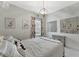 This bedroom boasts modern chandelier, gray walls and neutral carpet flooring at 16966 Rosedown Gln, Parrish, FL 34219