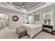 Spacious bedroom with tray ceilings, ceiling fan, decorative lighting, and large windows for natural light at 16966 Rosedown Gln, Parrish, FL 34219