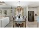 Bright dining room features a unique chandelier and sliding glass door access to the backyard at 16966 Rosedown Gln, Parrish, FL 34219