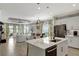 Bright, open-concept kitchen featuring an island with stainless steel appliances, white cabinetry and an eat-in bar at 16966 Rosedown Gln, Parrish, FL 34219