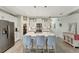 Well-lit kitchen features a spacious island, stainless steel appliances, white cabinetry, and an eat-in bar at 16966 Rosedown Gln, Parrish, FL 34219