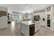Bright, open-concept kitchen featuring an island with stainless steel appliances, white cabinetry and an eat-in bar at 16966 Rosedown Gln, Parrish, FL 34219