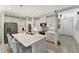 Modern kitchen with white cabinets, stainless steel appliances, and a large island with seating at 16966 Rosedown Gln, Parrish, FL 34219
