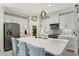 Well-lit kitchen features a spacious island, stainless steel appliances, white cabinetry, and an eat-in bar at 16966 Rosedown Gln, Parrish, FL 34219