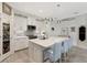 Well-lit kitchen features a spacious island, stainless steel appliances, white cabinetry, and an eat-in bar at 16966 Rosedown Gln, Parrish, FL 34219