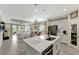 Bright, open-concept kitchen featuring an island with stainless steel appliances, white cabinetry and an eat-in bar at 16966 Rosedown Gln, Parrish, FL 34219