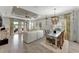 Bright, open-concept living room with tile flooring, white sofa, and stylish ceiling fan at 16966 Rosedown Gln, Parrish, FL 34219