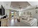 This living room boasts tile flooring, a ceiling fan, and sliding glass doors to the porch at 16966 Rosedown Gln, Parrish, FL 34219