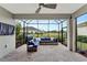 Inviting screened-in patio with comfortable seating and a view of the manicured backyard at 16966 Rosedown Gln, Parrish, FL 34219