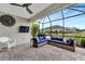 Relaxing screened-in lanai with stylish furniture, ceiling fan, and open views at 16966 Rosedown Gln, Parrish, FL 34219