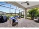 Outdoor patio features a sleek fan, brick floors, grill, and a comfortable seating area at 16966 Rosedown Gln, Parrish, FL 34219
