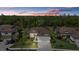 Aerial view of a luxurious home with a tile roof, three car garage, and lush landscaping at 17045 Polo Trl, Bradenton, FL 34211