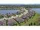 Aerial view of a residential community featuring several homes along a large lake at 17045 Polo Trl, Bradenton, FL 34211