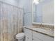 Bathroom featuring a toilet and vanity with granite countertops and framed mirror at 17045 Polo Trl, Bradenton, FL 34211