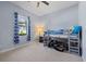Bedroom featuring a bunk bed near a window with blue curtains and neutral walls at 17045 Polo Trl, Bradenton, FL 34211
