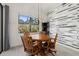 Dining area features a wood table and chairs, stylish light fixture, and accent wall at 17045 Polo Trl, Bradenton, FL 34211