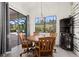 Dining room with wooden table, chairs, view to outdoor living space, and stylish decor at 17045 Polo Trl, Bradenton, FL 34211