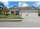 Well-maintained home with a two-car garage, tiled roof, and professionally landscaped front yard at 17045 Polo Trl, Bradenton, FL 34211