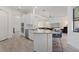 Open kitchen with a center island, stainless appliances, and adjacent living room at 17045 Polo Trl, Bradenton, FL 34211