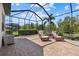 Covered, screened-in lanai with patio furniture and views of the yard at 17045 Polo Trl, Bradenton, FL 34211