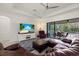 Living room with leather sectional, ceiling fan, and view of the lanai at 17045 Polo Trl, Bradenton, FL 34211