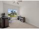 Well-lit home office with a large window, desk setup, and organized storage at 17045 Polo Trl, Bradenton, FL 34211