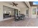 Covered patio with dining table and outdoor grill, perfect for entertaining at 17045 Polo Trl, Bradenton, FL 34211