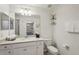 Bright bathroom features a large mirror, white vanity, and modern fixtures at 17902 Gawthrop Dr # 302, Lakewood Ranch, FL 34211
