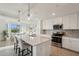 Bright, open kitchen with white cabinetry, stainless steel appliances, and quartz countertops, offering a modern design at 17902 Gawthrop Dr # 302, Lakewood Ranch, FL 34211