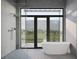 Spa-like bathroom with a freestanding tub, a frameless glass shower, and stylish fixtures at 2100 Mcclellan Pkwy, Sarasota, FL 34239