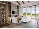 Bright living room with large windows, modern furnishings, and a sleek fireplace with marble accent wall at 2100 Mcclellan Pkwy, Sarasota, FL 34239