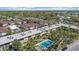 Aerial view of the community and its pool with lush green landscaping around the building at 2155 Wood St # A20, Sarasota, FL 34237