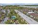 Overhead view of the yellow apartments, pool, and surrounding greenery at 2155 Wood St # A20, Sarasota, FL 34237
