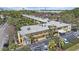 Aerial view of the yellow apartment building surrounded by green trees at 2155 Wood St # A20, Sarasota, FL 34237